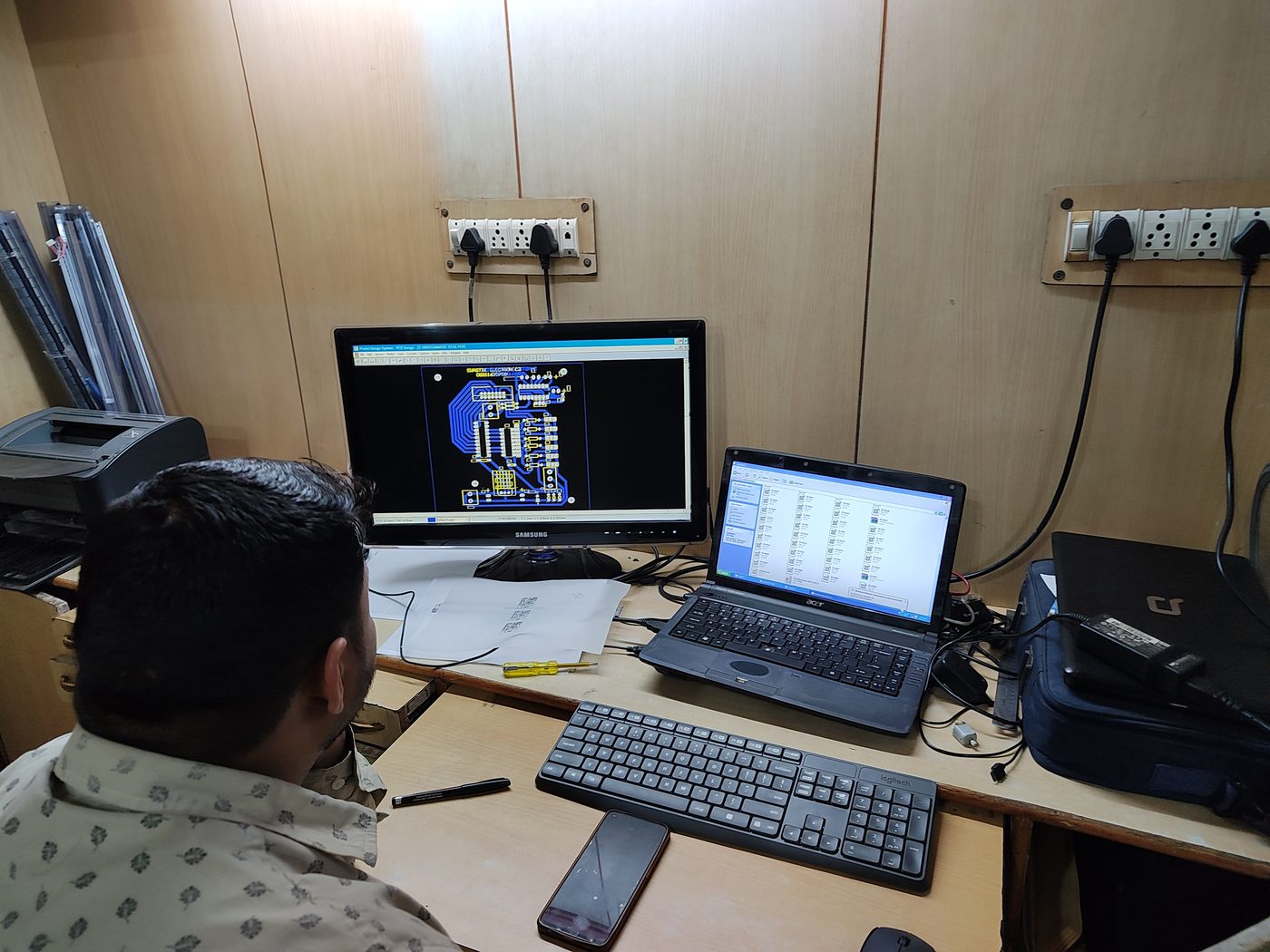 Technician reviewing a circuit board layout on screen during repair diagnosis