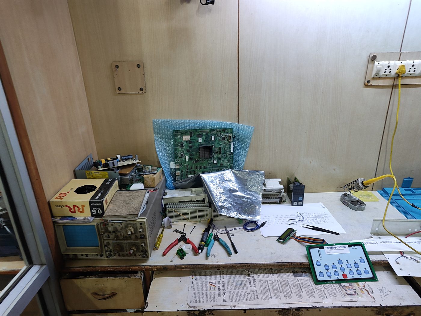Electronics workbench with a device mainboard under repair