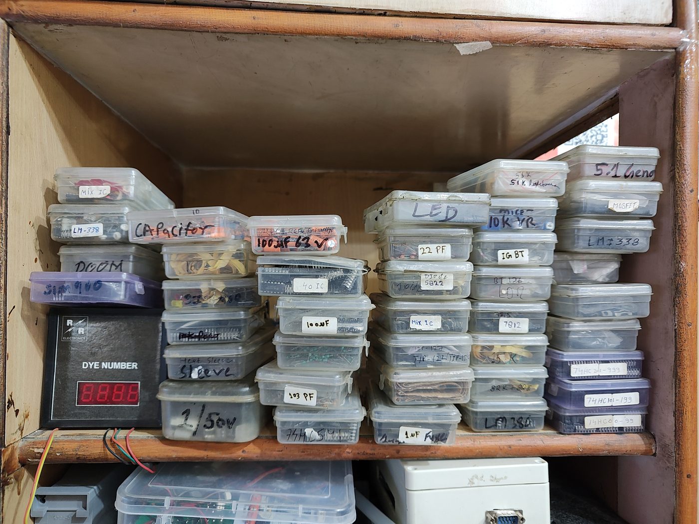 Labelled bins of ICs, resistors and capacitors in the spare-parts inventory